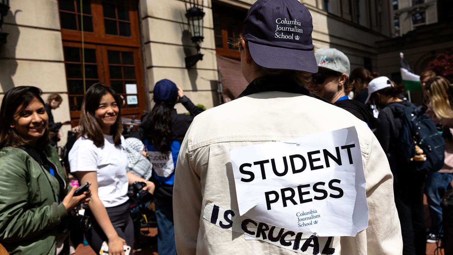A Columbia Journalism student journalist shows off their sign as they cover the events at Hamilton Hall at Columbia University on April 30, 2024 in New York City.