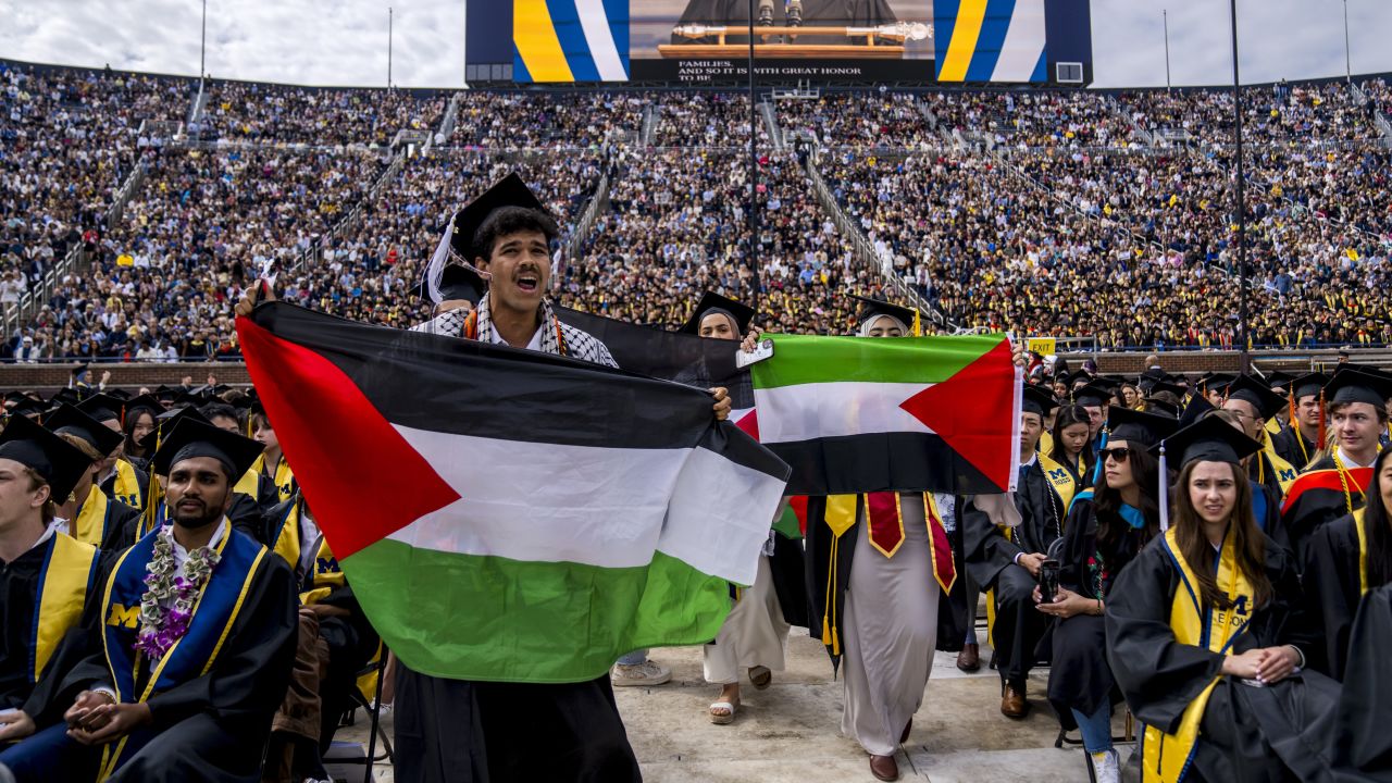 Students protest in support of Palestine during the University of Michigan's Spring Commencement ceremony on May 4, 2024 at Michigan Stadium in Ann Arbor, Michigan. A group of students called for the University of Michigan to divest from companies with ties to Israel during the spring commencement ceremony.