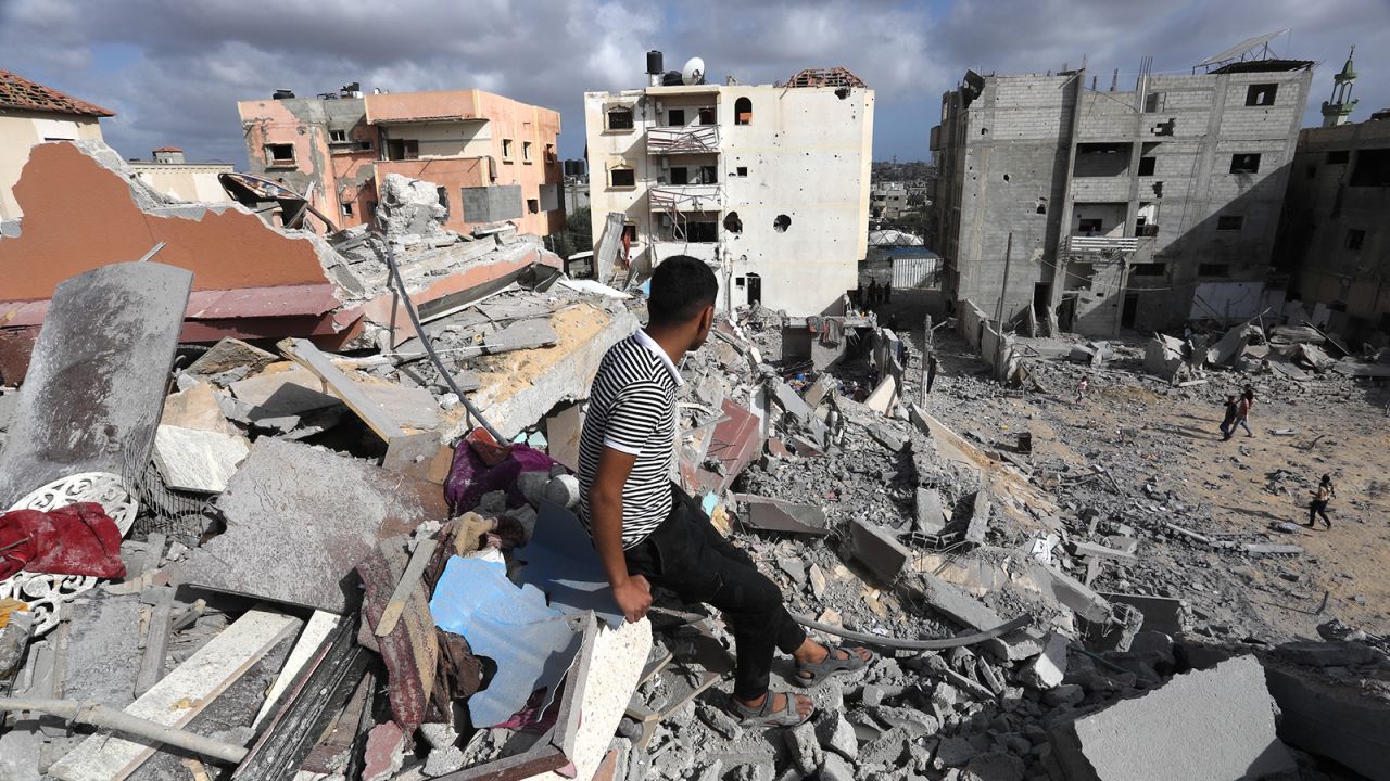 A man sits on the rubbles as Palestinians search for usable items among the debris of destroyed building following the Israeli attacks on the al-Salam Neighborhood in Rafah, Gaza on May 5, 2024.