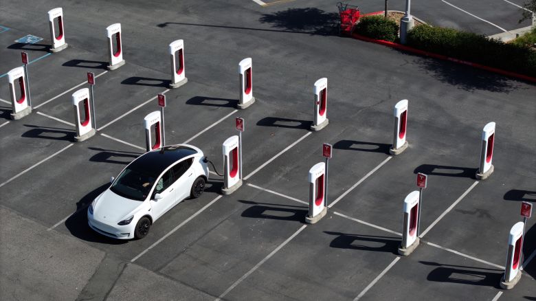 In an aerial view, a Tesla car charges up at a Tesla Supercharger on May 02, 2024 in Petaluma, California.