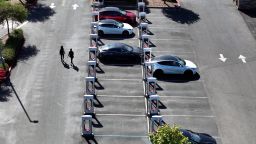 In an aerial view, Tesla cars charge up at a Tesla Supercharger on May 02, 2024 in Petaluma, California.