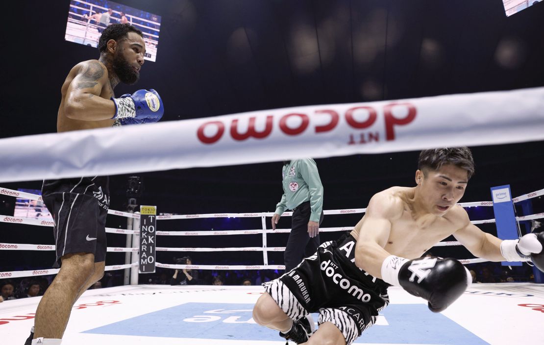 Luis Nery (left) knocks down Inoue in the first round of their super bantamweight boxing title match.