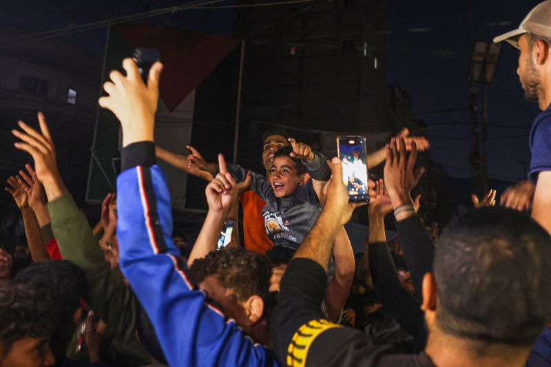 TOPSHOT - Palestinians celebrate in a street in Rafah, in the southern Gaza Strip, after Hamas announced it has accepted a truce proposal on May 6, 2024, amid the ongoing conflict between Israel and the Palestinian militant group Hamas. Hamas leader Ismail Haniyeh on May 6, informed mediators Qatar and Egypt that his Palestinian militant group had accepted their proposal for a ceasefire in Gaza after nearly seven months of war. (Photo by AFP) (Photo by -/AFP via Getty Images)