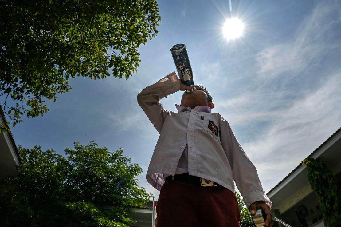 A student drinks water outside a school in Banda Aceh, Indonesia on May 7, 2024.