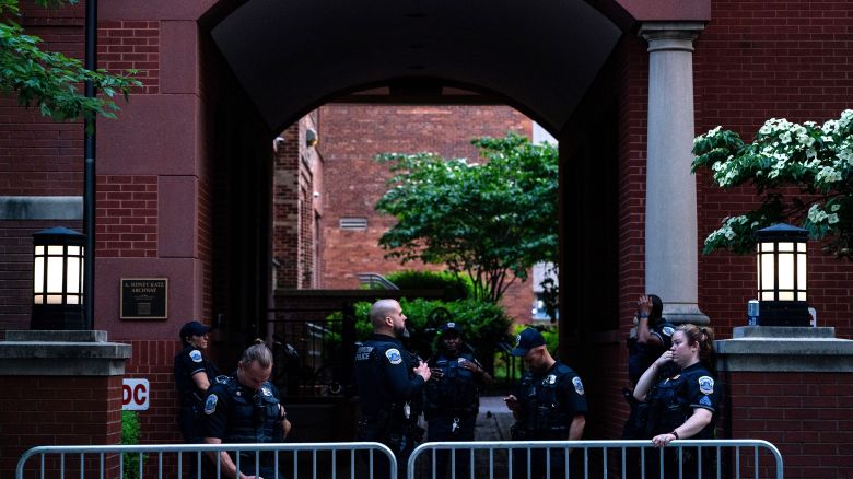 Law Enforcement stand behind barricades where they cleared out a Pro-Palestinian encampment at George Washington University's University Yard.