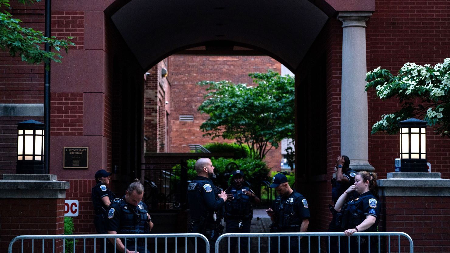 Law enforcement officers stand behind barricades where they cleared out a pro-Palestinian encampment Wednesday at George Washington University's University Yard.