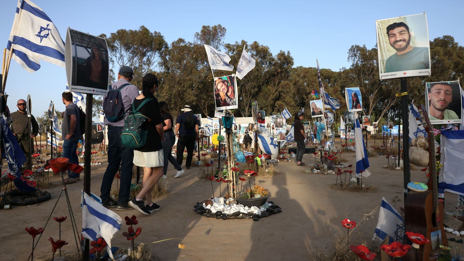 Visitors walk through a memorial to those abducted or killed in the Hamas attack on the Nova music festival on October 7.