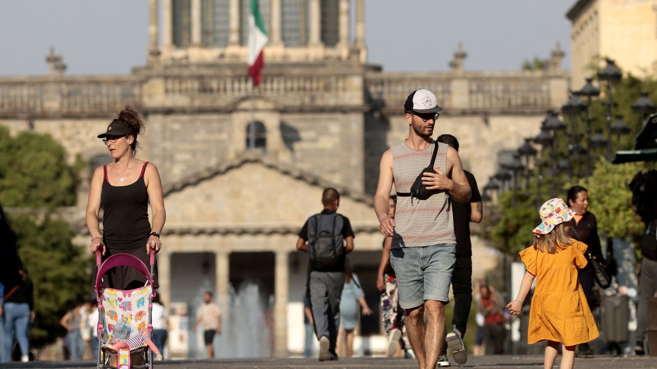 People walk in the the sun during a heat wave hitting the country, in Guadalajara, Jalisco state, Mexico, on May 9, 2024. More than a dozen states in Mexico reached a record maximum of 45°C. (Photo by ULISES RUIZ / AFP) (Photo by ULISES RUIZ/AFP via Getty Images)