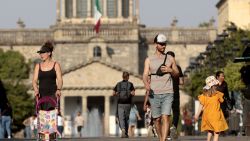 People walk in the the sun during a heat wave hitting the country, in Guadalajara, Jalisco state, Mexico, on May 9, 2024. More than a dozen states in Mexico reached a record maximum of 45°C. (Photo by ULISES RUIZ / AFP) (Photo by ULISES RUIZ/AFP via Getty Images)