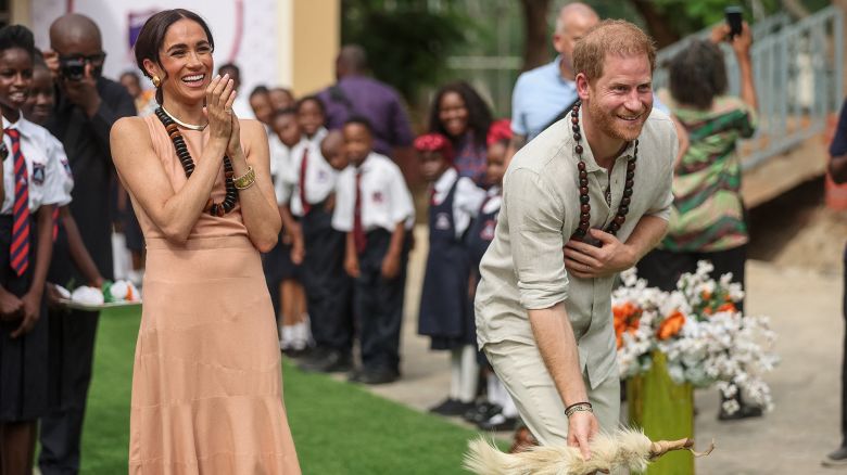 TOPSHOT - Britain's Prince Harry (R), Duke of Sussex, and Britain's Meghan (L), Duchess of Sussex, take part in activities as they arrive at the Lightway Academy in Abuja on May 10, 2024 as they visit Nigeria as part of celebrations of Invictus Games anniversary. (Photo by Kola SULAIMON / AFP) (Photo by KOLA SULAIMON/AFP via Getty Images)