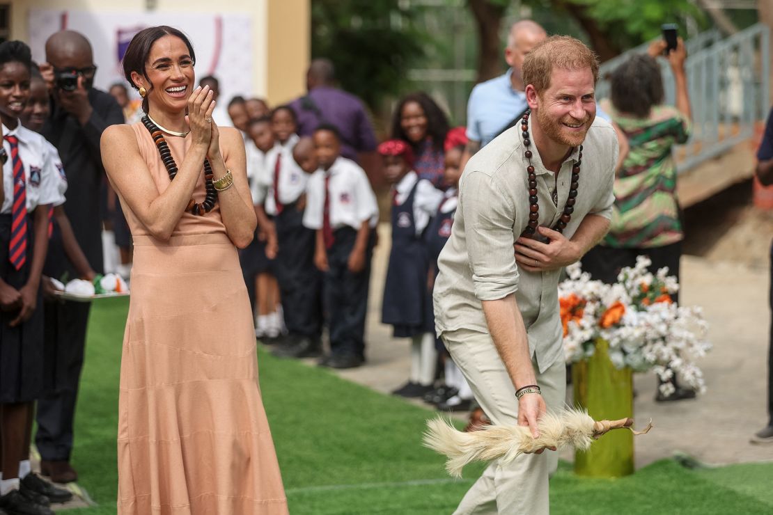 Britain's Prince Harry, Duke of Sussex, and Meghan, Duchess of Sussex, take part in activities as they arrive at the Lightway Academy in Abuja on May 10, 2024.