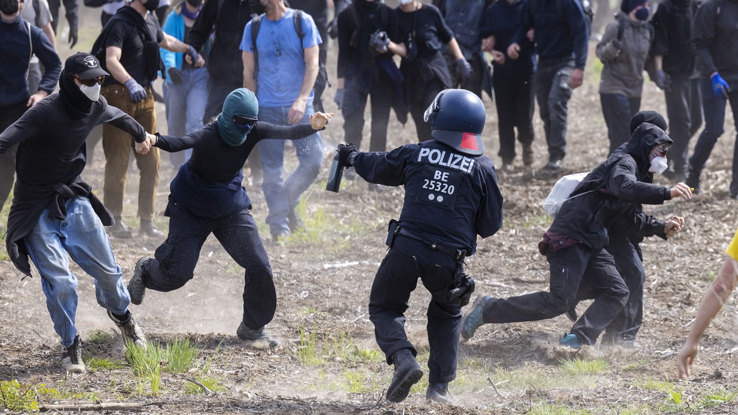 Police confront environmental activists in a forest near Tesla's factory in Germany on May 10, 2024.