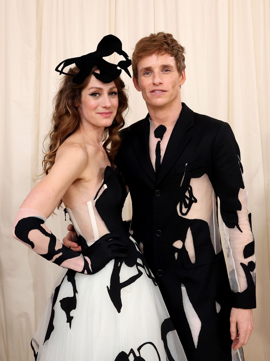 Hannah Bagshawe and Eddie Redmayne attend the event in matching Steve O Smith designs. Redmayne's suit featured large cut-outs filled with sheer flesh-toned fabric.