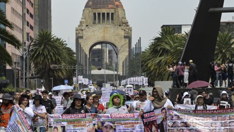 Mothers and relatives of missing persons in different states of Mexico carry signs with photos of their loved ones while participating in a march to demand that the government clarify the disappearances within the framework of Mother's Day in Mexico City on May 10, 2024. (Photo by Yuri CORTEZ / AFP) (Photo by YURI CORTEZ/AFP via Getty Images)