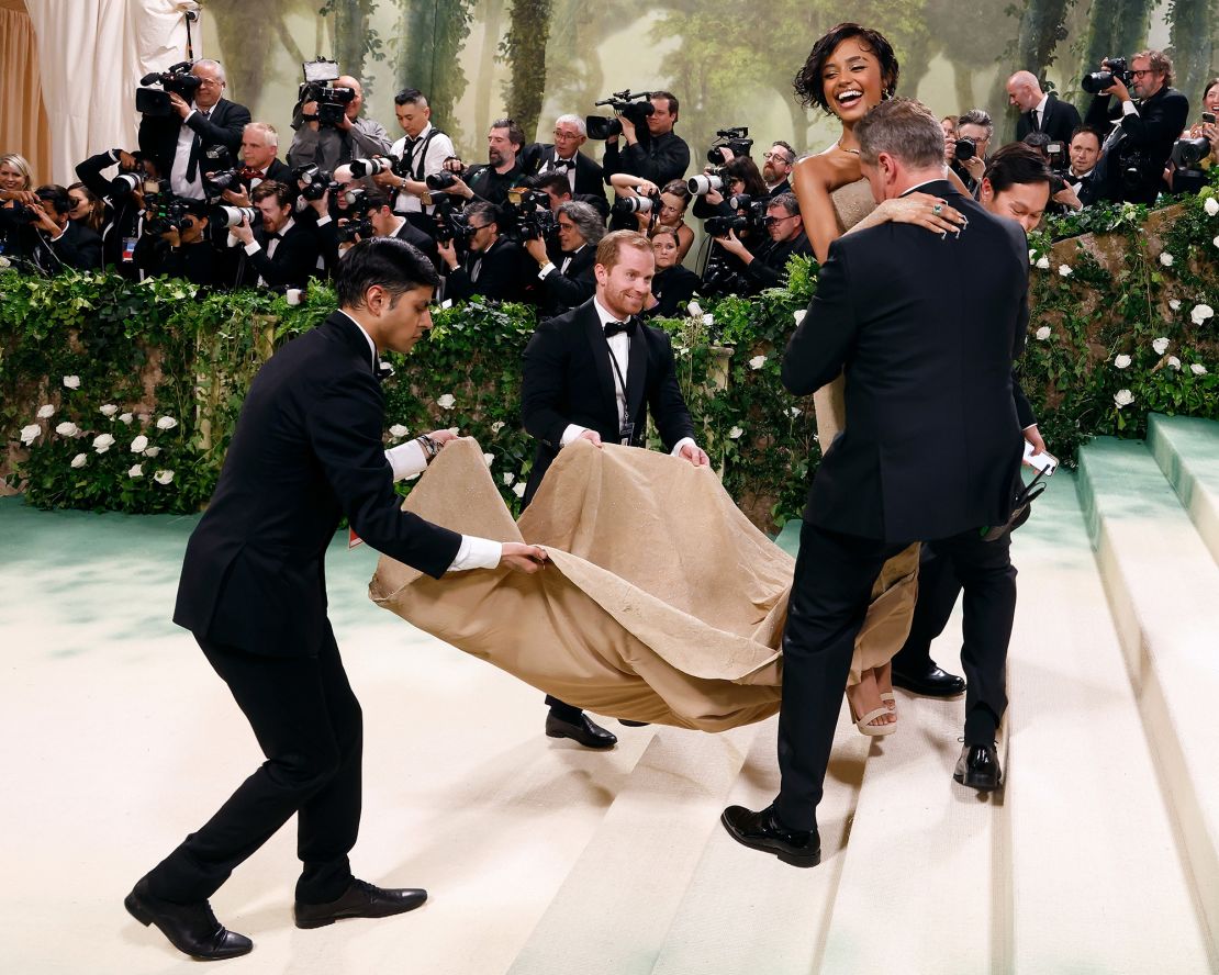 Tyla is carried up the Met Gala steps in 2024.