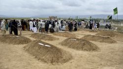 Afghan relatives offer prayers during a burial ceremony, near the graves of victim who lost their lives following flash floods after heavy rainfall at a village in Baghlan-e-Markazi district of Baghlan province on May 11, 2024. More than 300 people were killed in flash flooding in Afghanistan's northern province of Baghlan, the World Food Programme said on May 11. (Photo by Atif Aryan / AFP) (Photo by ATIF ARYAN/AFP via Getty Images)