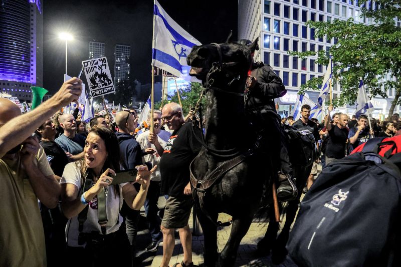 Israeli mounted police deploy during a rally calling for the release of hostages held in Gaza outside the defense ministry headquarters in Tel Aviv on May 11, 2024.