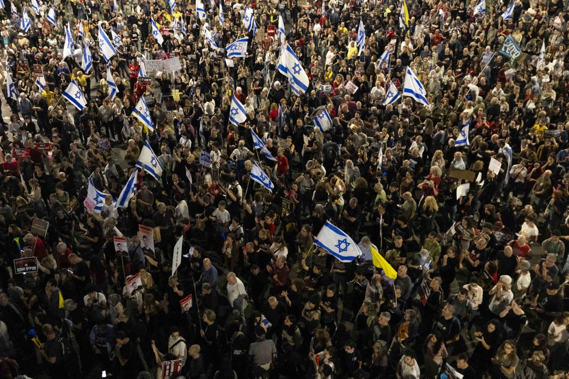Protesters hold flags and signs during a demonstration calling for a hostages deal with Hamas and against Netanyahu and his government, in Tel Aviv, Israel on May 11.