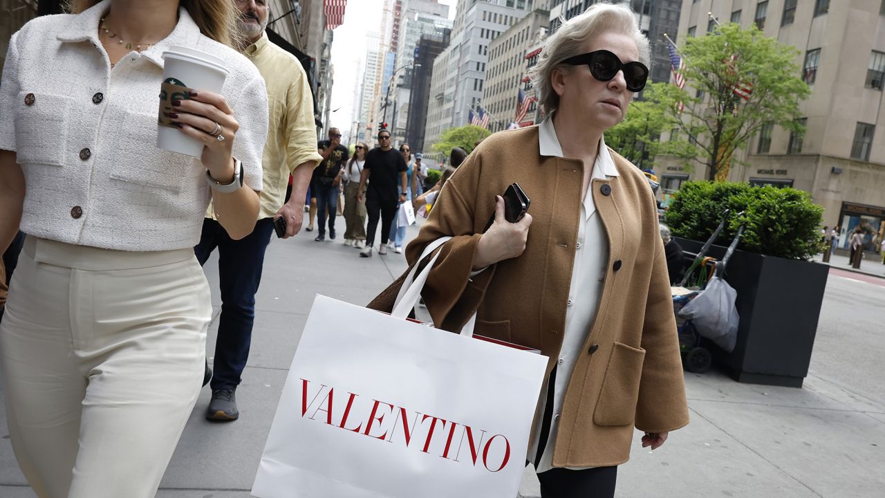 People walk along Fifth Avenue with shopping bags on May 08, 2024, in New York City.