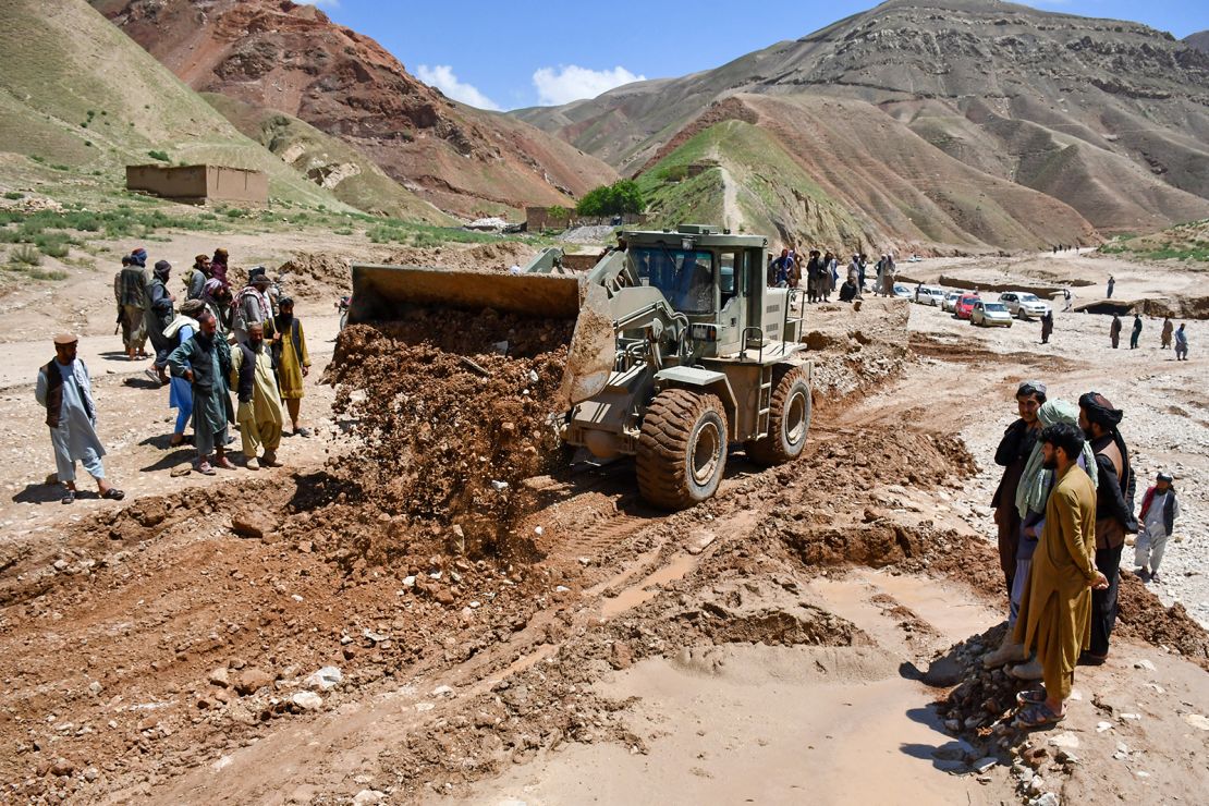 Workers repair a road destroyed by floods in Nahrin district of Baghlan province on May 12, 2024.