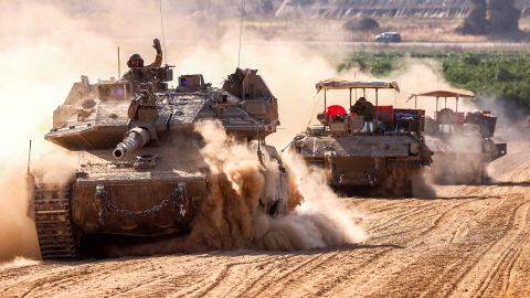Israeli army battle tanks move near the border with the Gaza Strip at a location in southern Israel on May 13, 2024, amid the ongoing conflict in the Palestinian territory between Israel and the Hamas movement. (Photo by JACK GUEZ / AFP) (Photo by JACK GUEZ/AFP via Getty Images)