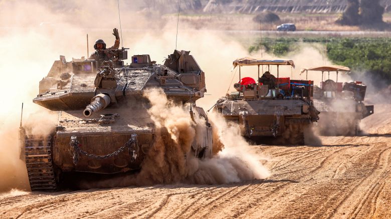 Israeli army battle tanks move near the border with the Gaza Strip at a location in southern Israel on May 13, 2024, amid the ongoing conflict in the Palestinian territory between Israel and the Hamas movement. (Photo by JACK GUEZ / AFP) (Photo by JACK GUEZ/AFP via Getty Images)
