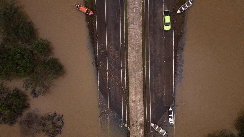 TOPSHOT - Ariel view showing the flooded ERS-448 road in Canoas, Rio Grande do Sul state, Brazil, on May 13, 2024. Brazil's President Luiz Inacio Lula da Silva on Monday put off a state visit to Chile to focus on the historic floods in the south of the country that have left 147 dead. Torrential rains since the beginning of the month in Rio Grande do Sul state have caused rivers to burst their banks, leaving towns and parts of the bustling state capital Porto Alegre under water. Around two million people have been affected, more than 600,000 of whom were forced from their homes due to the disaster, which experts attribute to climate change and the El Nino weather phenomenon. (Photo by Nelson ALMEIDA / AFP) (Photo by NELSON ALMEIDA/AFP via Getty Images)