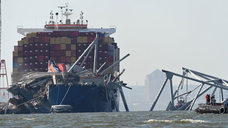 A section of the Francis Scott Key Bridge rests in the water next to the Dali container ship in Baltimore on May 13, 2024 after crews conducted a controlled demolition. The Francis Scott Key Bridge, a major transit route into the busy port of Baltimore, collapsed on March 26 when the Dali container ship lost power and collided into a support column, killing six roadway construction workers. (Photo by ROBERTO SCHMIDT / AFP) (Photo by ROBERTO SCHMIDT/AFP via Getty Images)