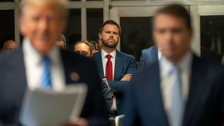 NEW YORK, NEW YORK - MAY 13: U.S. Sen. JD Vance (R-OH) looks on as former President Donald Trump speaks to the media during Trump's trial for allegedly covering up hush money payments at Manhattan Criminal Court on May 13, 2024 in New York City. Trump faces 34 felony counts of falsifying business records in the first of his criminal cases to go to trial. (Photo by Mark Peterson/Pool/Getty Images)