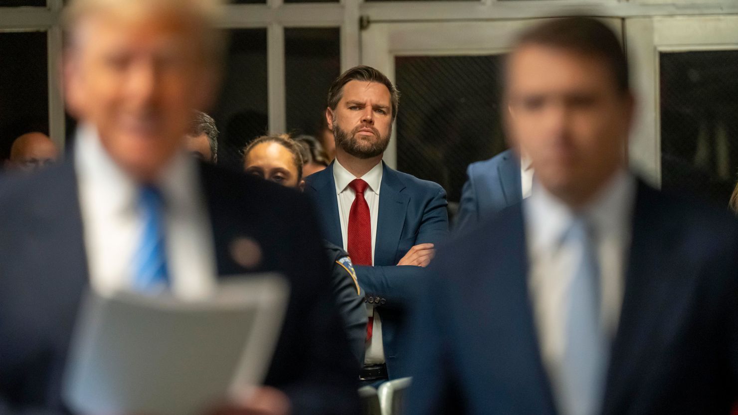 US Sen. JD Vance looks on as former President Donald Trump speaks to the media during Trump's trial for allegedly covering up hush money payments at Manhattan Criminal Court on May 13, 2024 in New York City.