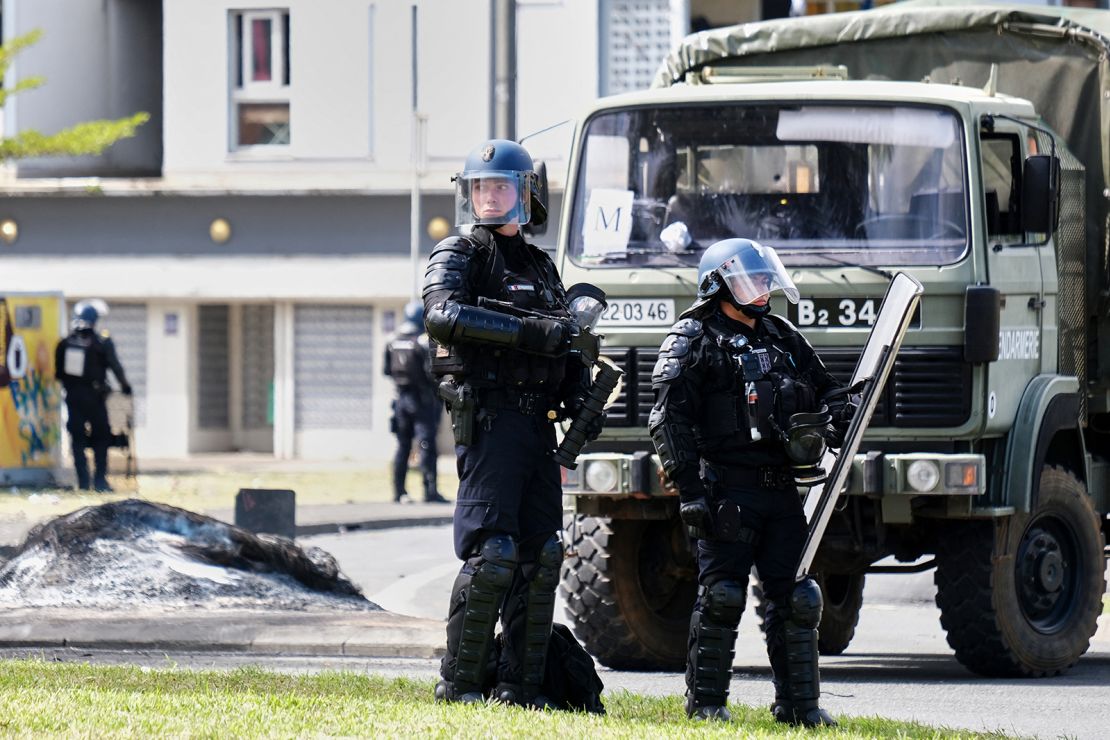 French gendarme officers guard the entrance of the Vallee-du-Tir district, in Noumea, New Caledonia on May 14, 2024.