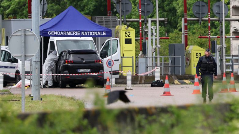 A forensic is at work at the site of a ramming attack which took place late morning at a road toll in Incarville in the Eure region of northern France, on May 14, 2024. Two French prison officers were killed and two others wounded on May 14 in an attack on a prison van transporting an inmate who escaped, a police source told AFP. (Photo by ALAIN JOCARD / AFP)