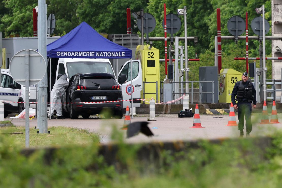 A forensics team inspects the site of a prison convoy ambush in France on Tuesday in which two guards were killed.
