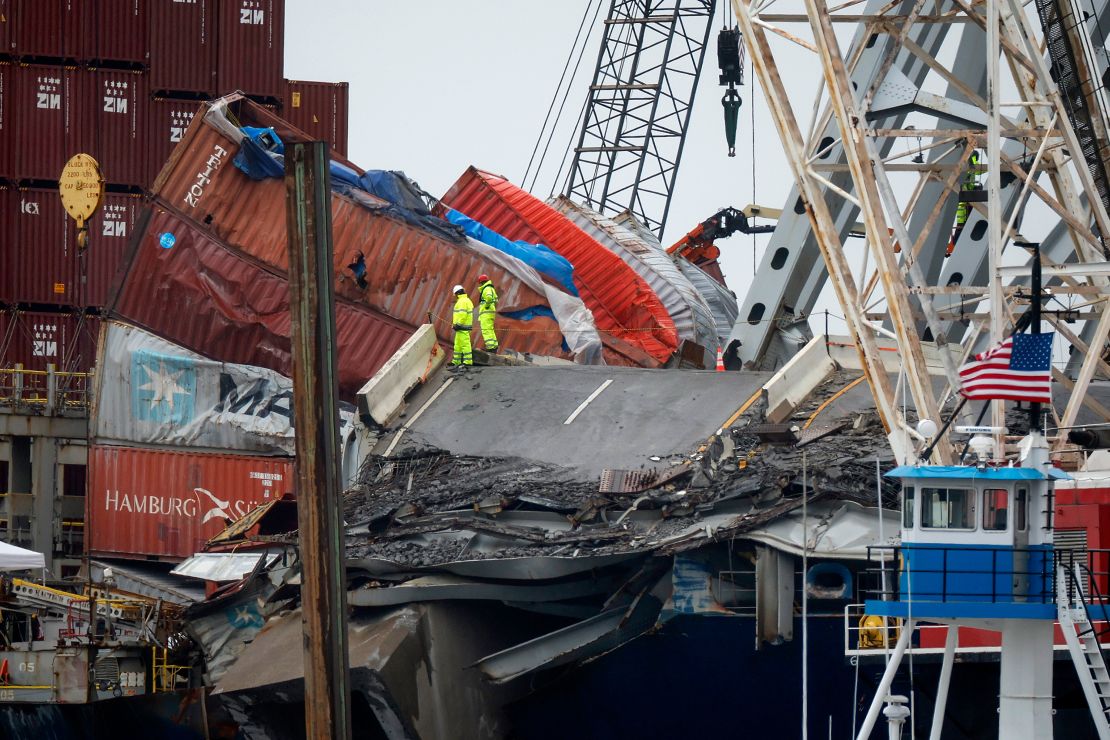 Salvage crew members work on the deck of the cargo ship Dali on Friday, May 10, 2024.