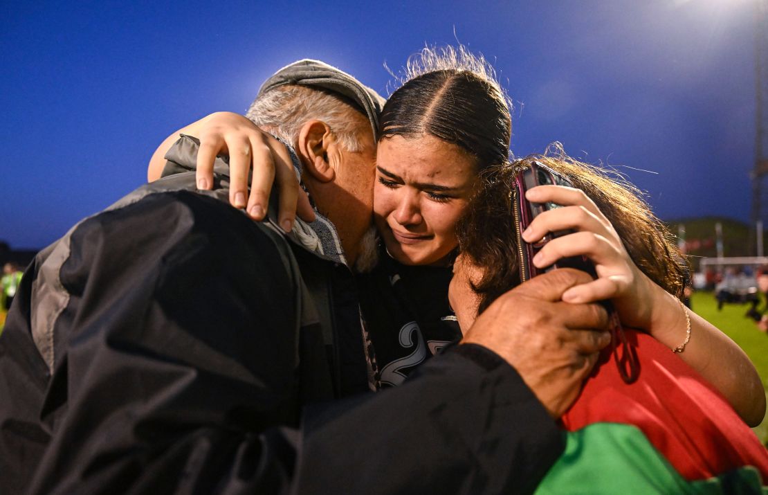 Palestinian women's team goalkeeper Charlotte Phillips with her grandparents George and Odette Dabit after the game at Dalymount Park in Dublin, Ireland.