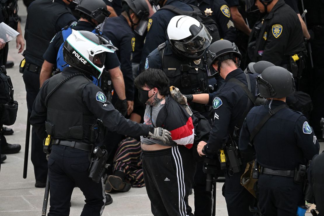 Police detain a pro-Palestinian demonstrator as they clear an encampment after protesters surrounded the Physical Sciences Lecture Hall at the University of California, Irvine, Wednesday.