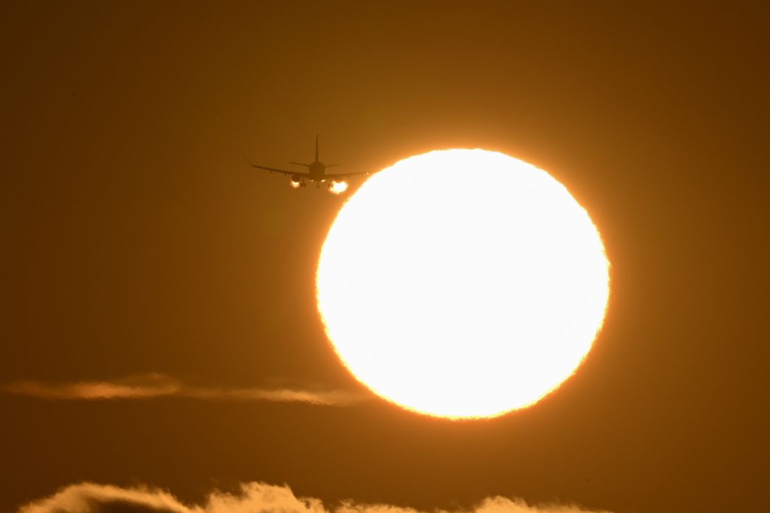 A plane arrives at San Francisco International Airport during sunset on May 15. Much of the country is forecast to have higher-than-average temperatures this summer. That could affect flights depending on how hot it gets.