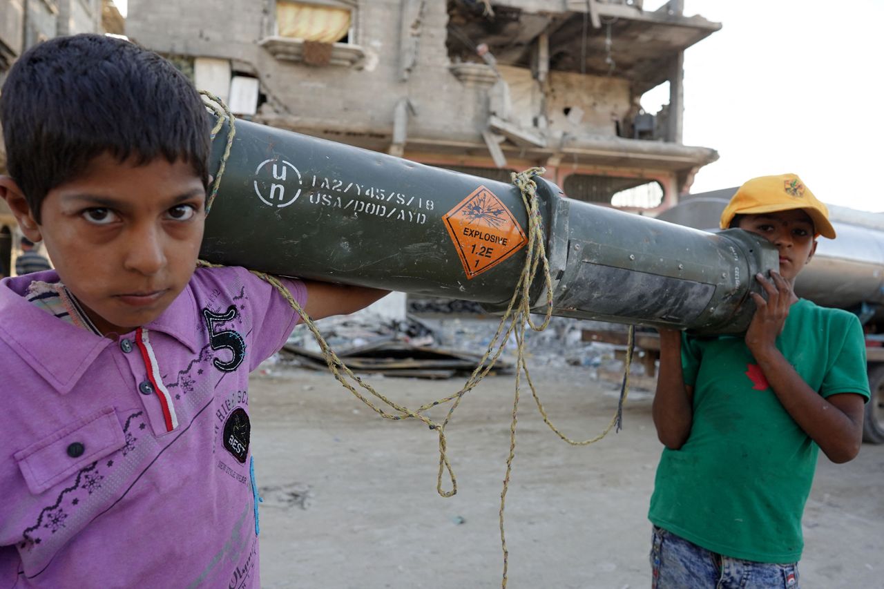 Palestinian children carry an empty US ammunition container in Khan Younis, southern Gaza, on May 16.