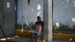 A relative of an ilegal Haitian migrants waits outside the Dominican Republic's Haina Temporary Detention Center, near Santo Domingo, on May 17, 2024. On the white sands of the Caribbean's top tourist destination, a concrete tower marks the first end of the 164-kilometer wall the Dominican Republic is building to "protect" itself from illegal immigration, violence and trafficking from Haiti. As the country prepares for its May 19 presidential election, troubled neighboring Haiti has been rocked by months of gang violence and political instability. (Photo by Federico PARRA / AFP) (Photo by FEDERICO PARRA/AFP via Getty Images)