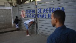 Relatives of ilegal Haitian migrants wait outside the Dominican Republic's Haina Temporary Detention Center, near Santo Domingo, on May 17, 2024. On the white sands of the Caribbean's top tourist destination, a concrete tower marks the first end of the 164-kilometer wall the Dominican Republic is building to "protect" itself from illegal immigration, violence and trafficking from Haiti. As the country prepares for its May 19 presidential election, troubled neighboring Haiti has been rocked by months of gang violence and political instability. (Photo by Federico PARRA / AFP) (Photo by FEDERICO PARRA/AFP via Getty Images)