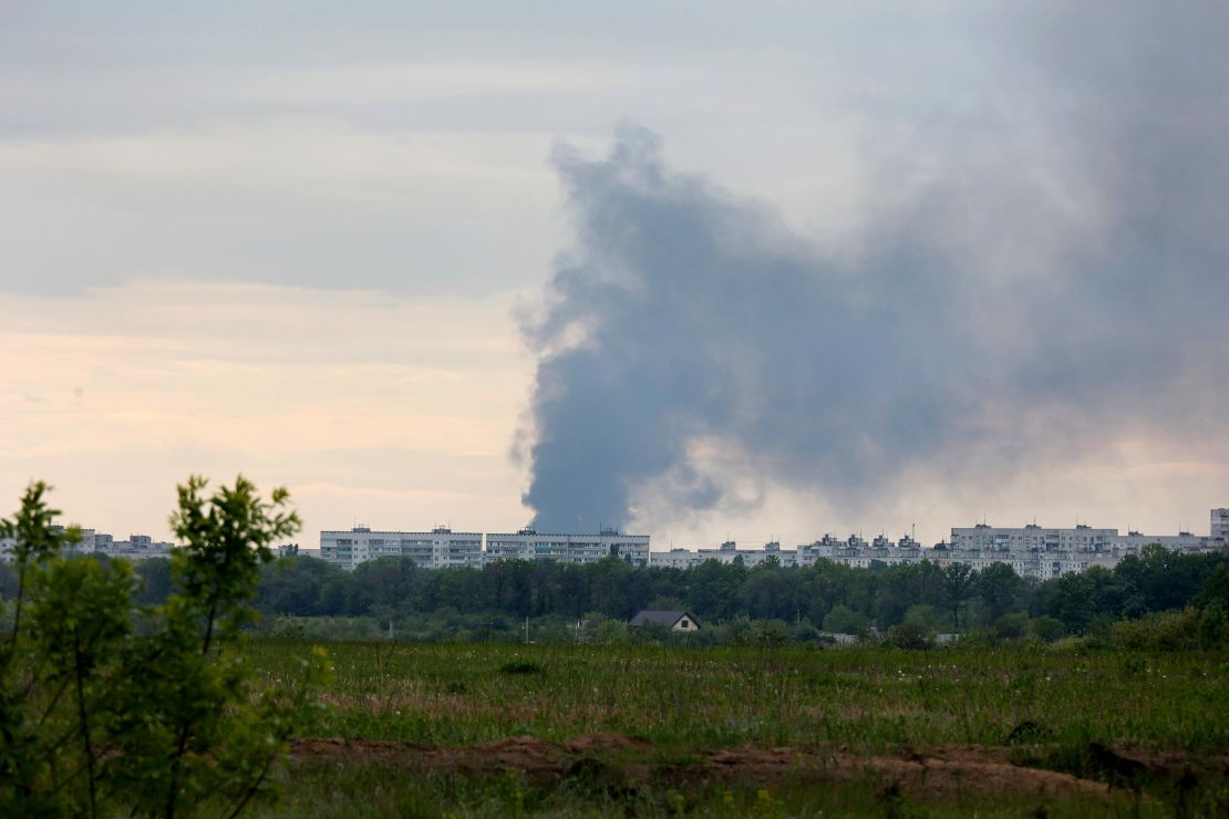 A pillar of smoke rises from behind apartment blocks after the shelling of Russian troops in Kharkiv on Friday.