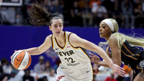 Caitlin Clark of the Indiana Fever dribbles against DiJonai Carrington of the Connecticut Sun during Clark's first WNBA game in Uncasville, Connecticut on May 14, 2024.