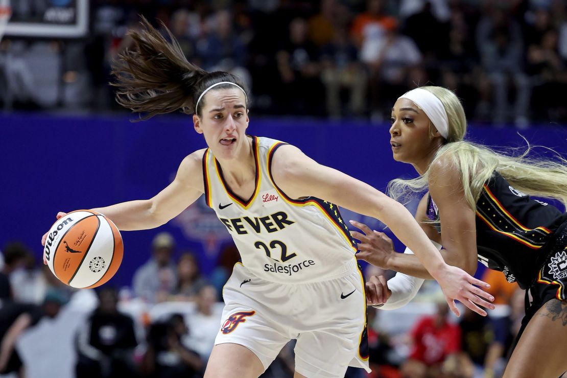 Caitlin Clark of the Indiana Fever dribbles against DiJonai Carrington of the Connecticut Sun during Clark's first WNBA game in Uncasville, Connecticut on May 14.