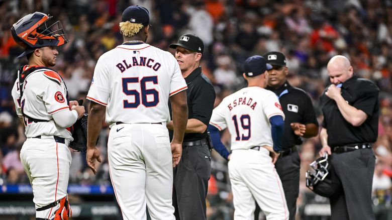 HOUSTON, TEXAS - MAY 14: Joe Espada #19 of the Houston Astros speaks with umpires after the ejection of Ronel Blanco #56 of the Houston Astros against the Oakland Athletics at Minute Maid Park on May 14, 2024 in Houston, Texas. (Photo by Logan Riely/Getty Images)