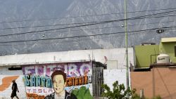 A man walks past a mural depicting SpaceX, X and electric car maker Tesla CEO Elon Musk in Santa Catarina, Nuevo Leon state, Mexico on April 29, 2024. Sparks fly as a laser slices through metal in a factory in Mexico, which is preparing for a new wave of foreign investment thanks to heightened tensions between the United States and China. Geopolitical frictions and supply chain gridlock during the Covid pandemic have prompted a growing number of companies to move manufacturing operations to the doorstep of the world's biggest economy. (Photo by ALFREDO ESTRELLA / AFP) (Photo by ALFREDO ESTRELLA/AFP via Getty Images)