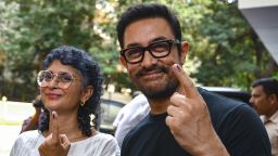 Bollywood actor Aamir Khan and director Kiran Rao after casting their votes at a polling station in India's general election, in Mumbai on May 20, 2024.