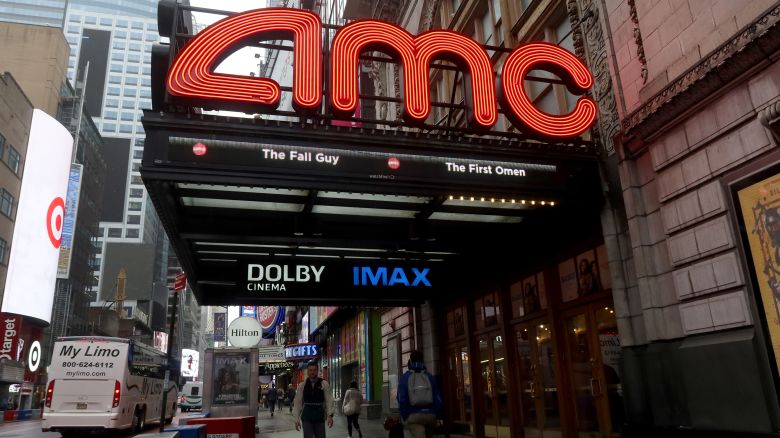 People walk past an AMC movie theater on 42nd Street in Times Square on May 16, 2024, in New York City.