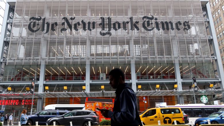 A person walks past the New York Times headquarters on 8th Avenue in New York City on May 16, 2024.