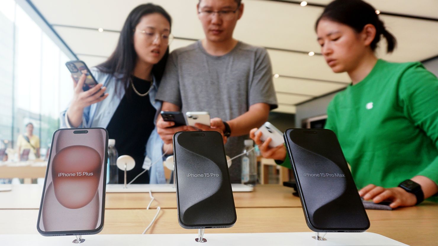 Customers shop for iPhone 15 at Apple's flagship store in Hangzhou, East China's Zhejiang province, on May 21, 2024.