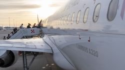 Sunrise and silhouette of engers boarding an Airbus A320 belonging to Spanish low-cost airline Volotea on the tarmac at Palermo airport in Sicily, Italy on 14 May 2024. (Photo by Antoine Boureau / Hans Lucas / Hans Lucas via AFP) (Photo by ANTOINE BOUREAU/Hans Lucas/AFP via Getty Images)